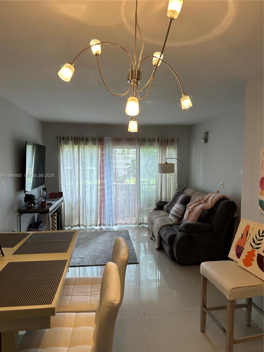 13810 Southwest 112th Street, Unit 106 Miami, FL 33186 - Photo 3 of 20 a living room with furniture a chandelier and a pool table