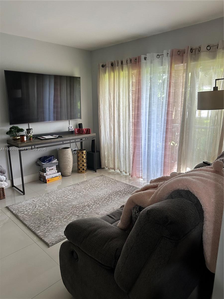 13810 Southwest 112th Street, Unit 106 Miami, FL 33186 - Photo 4 of 20 a bed sitting in a bedroom next to a window