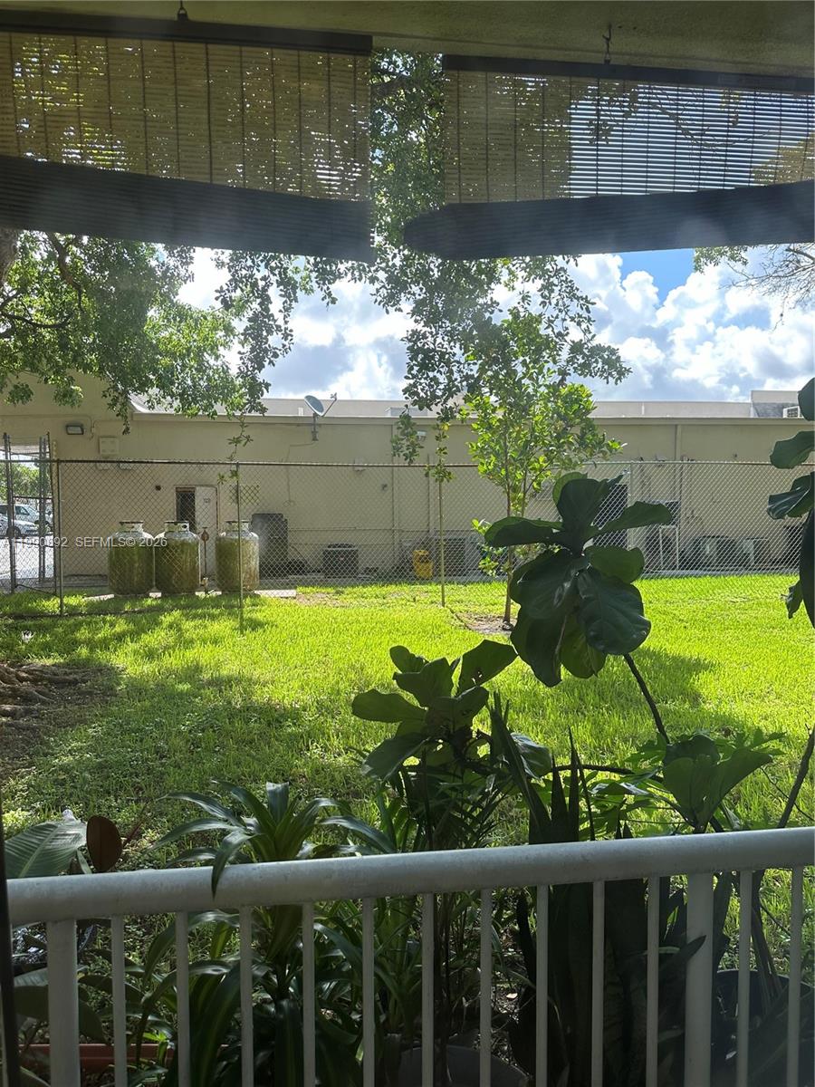 13810 Southwest 112th Street, Unit 106 Miami, FL 33186 - Photo 5 of 20 a view of a back yard from a lake