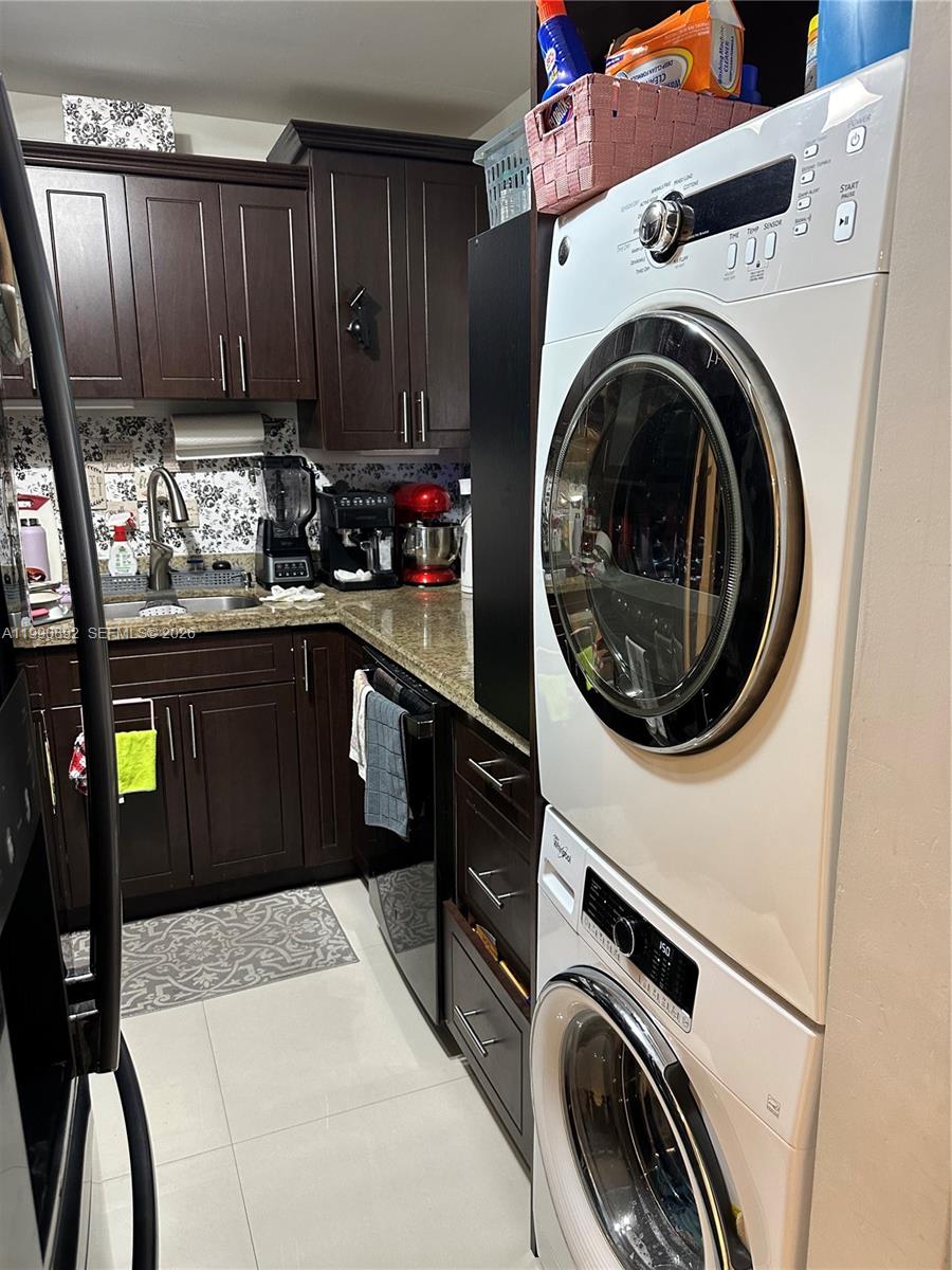 13810 Southwest 112th Street, Unit 106 Miami, FL 33186 - Photo 7 of 20 a kitchen with a washer and dryer