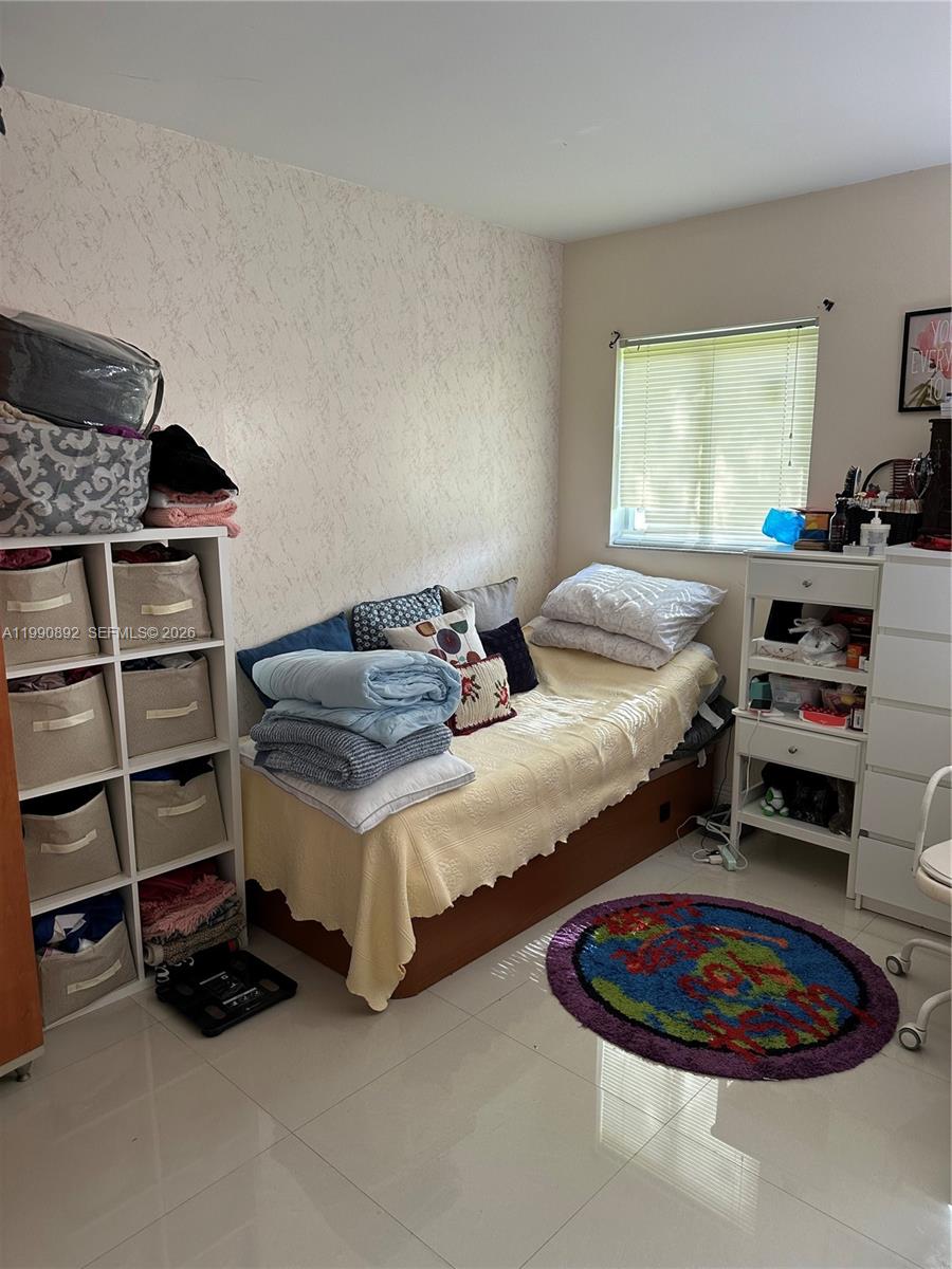 13810 Southwest 112th Street, Unit 106 Miami, FL 33186 - Photo 9 of 20 a bedroom with bed and a window