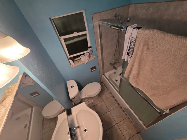 walk in closet with wooden floor washer and dryer