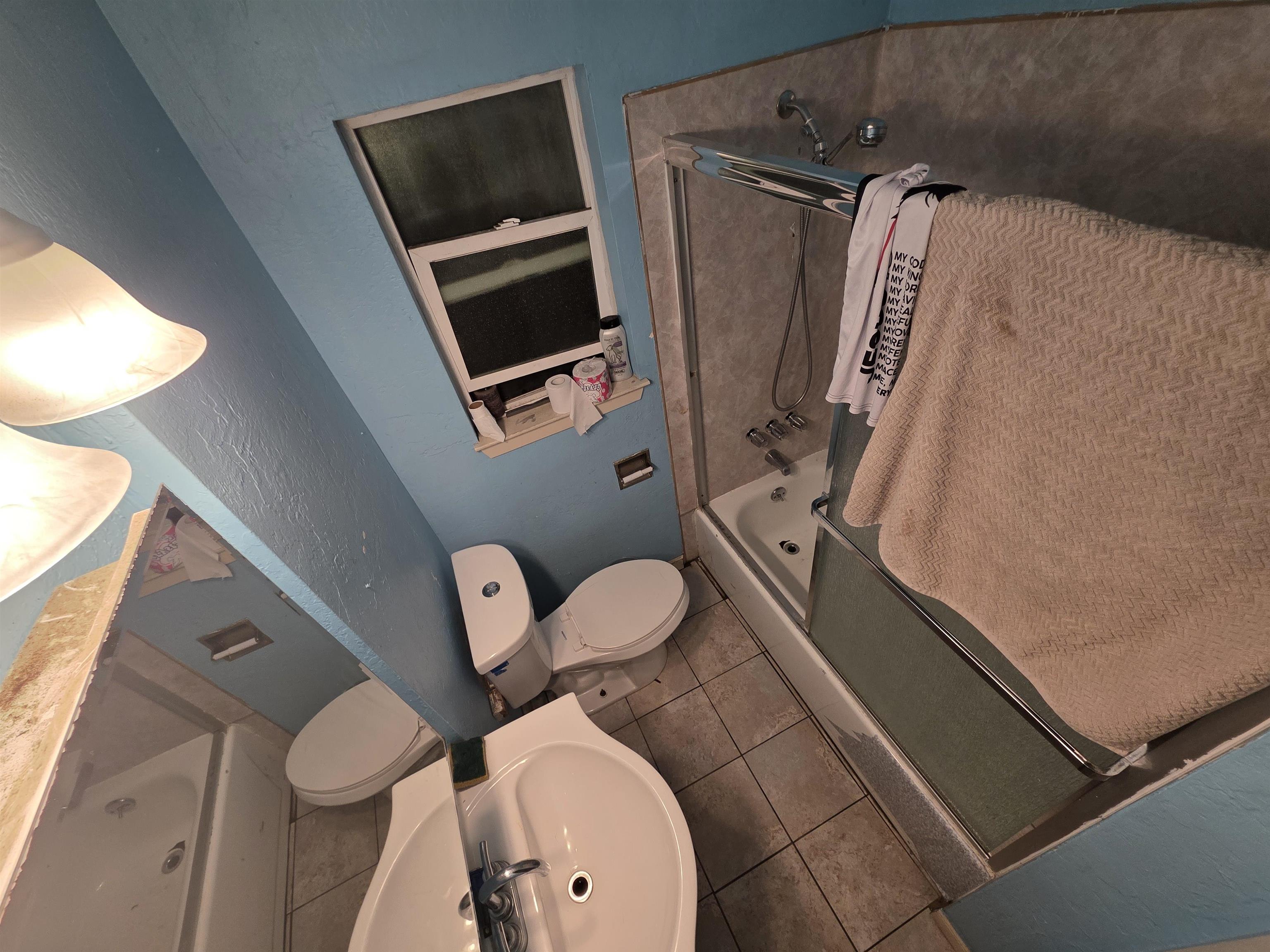 1823 Church Street Oakland, CA 94621 - Photo 2 of 18 Bathroom featuring tile patterned floors, shower / bath combination with glass door, and vanity