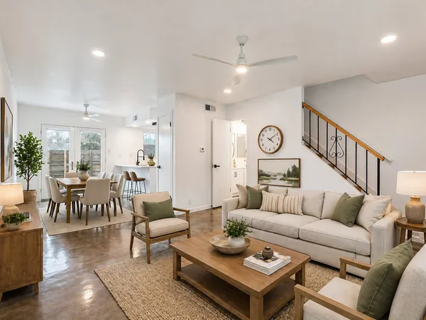 a living room with furniture a rug and a chandelier