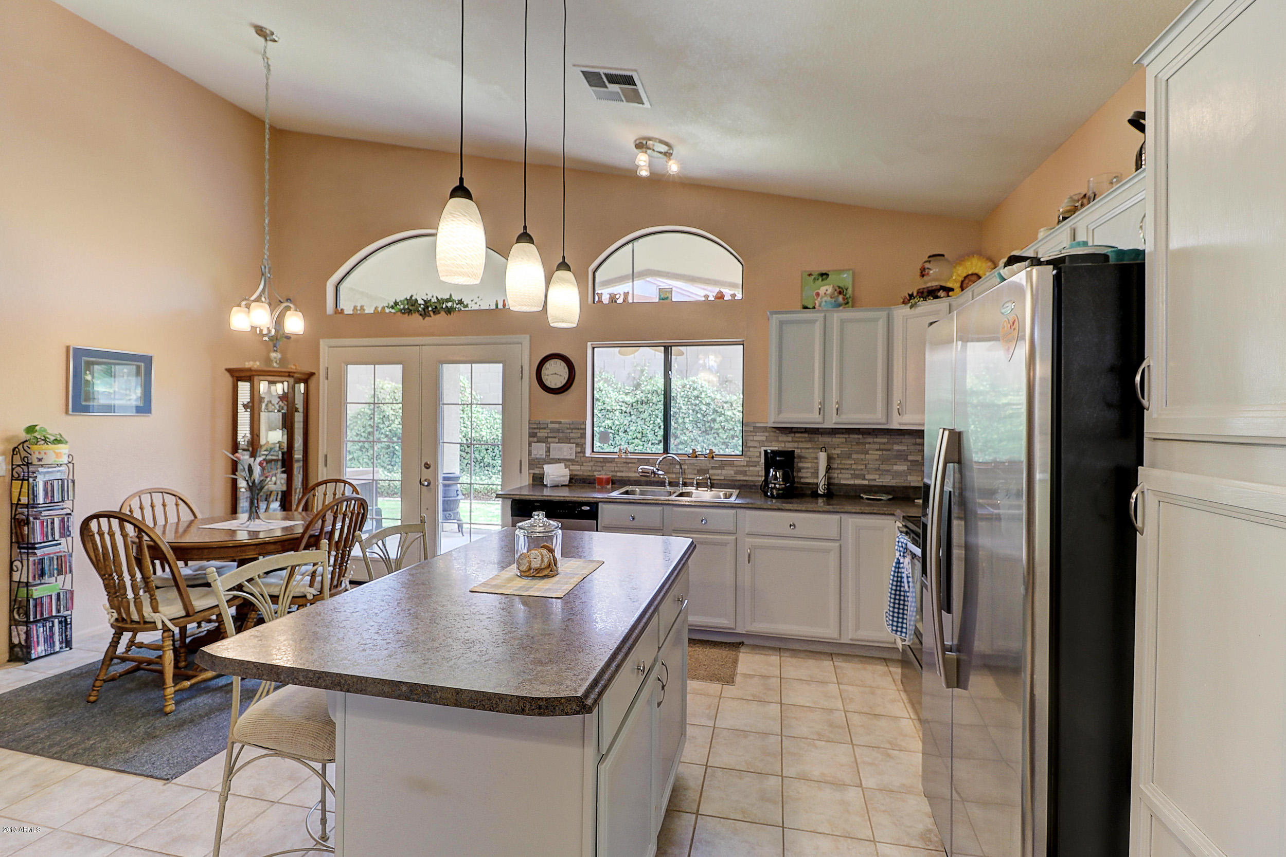 2101 East Escuda Road Phoenix, AZ 85024 - Photo 14 of 31 a kitchen with sink cabinets a dining table and chairs