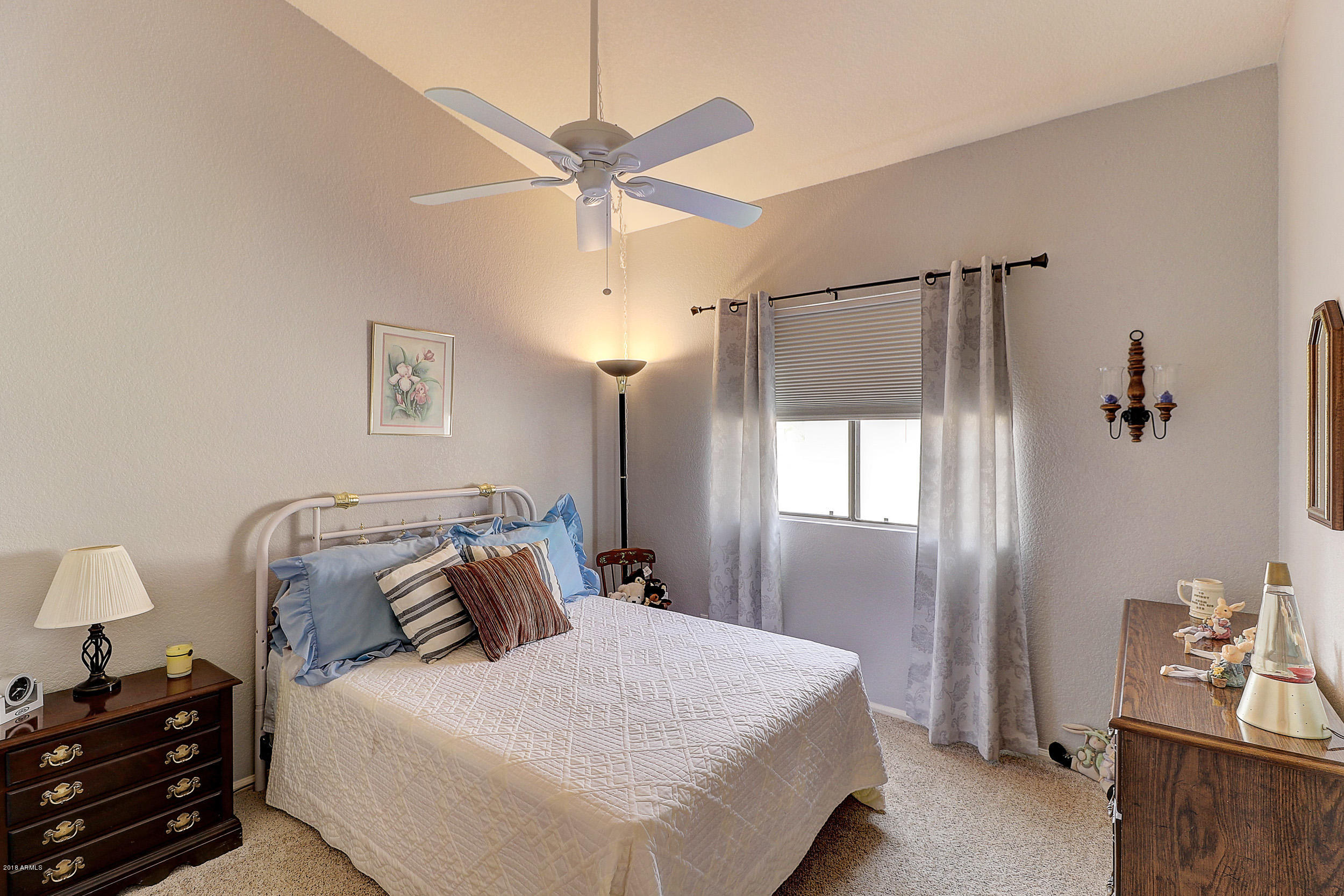 2101 East Escuda Road Phoenix, AZ 85024 - Photo 18 of 31 a bedroom with a bed and a chandelier