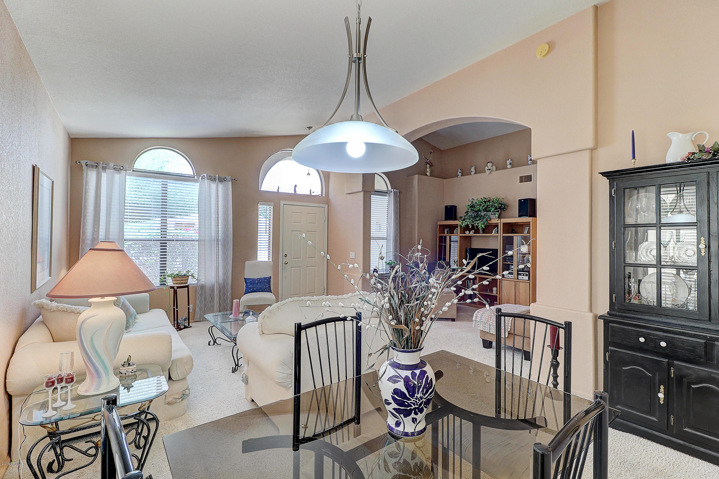 2101 East Escuda Road Phoenix, AZ 85024 - Photo 2 of 31 a dining room with furniture a chandelier and wooden floor