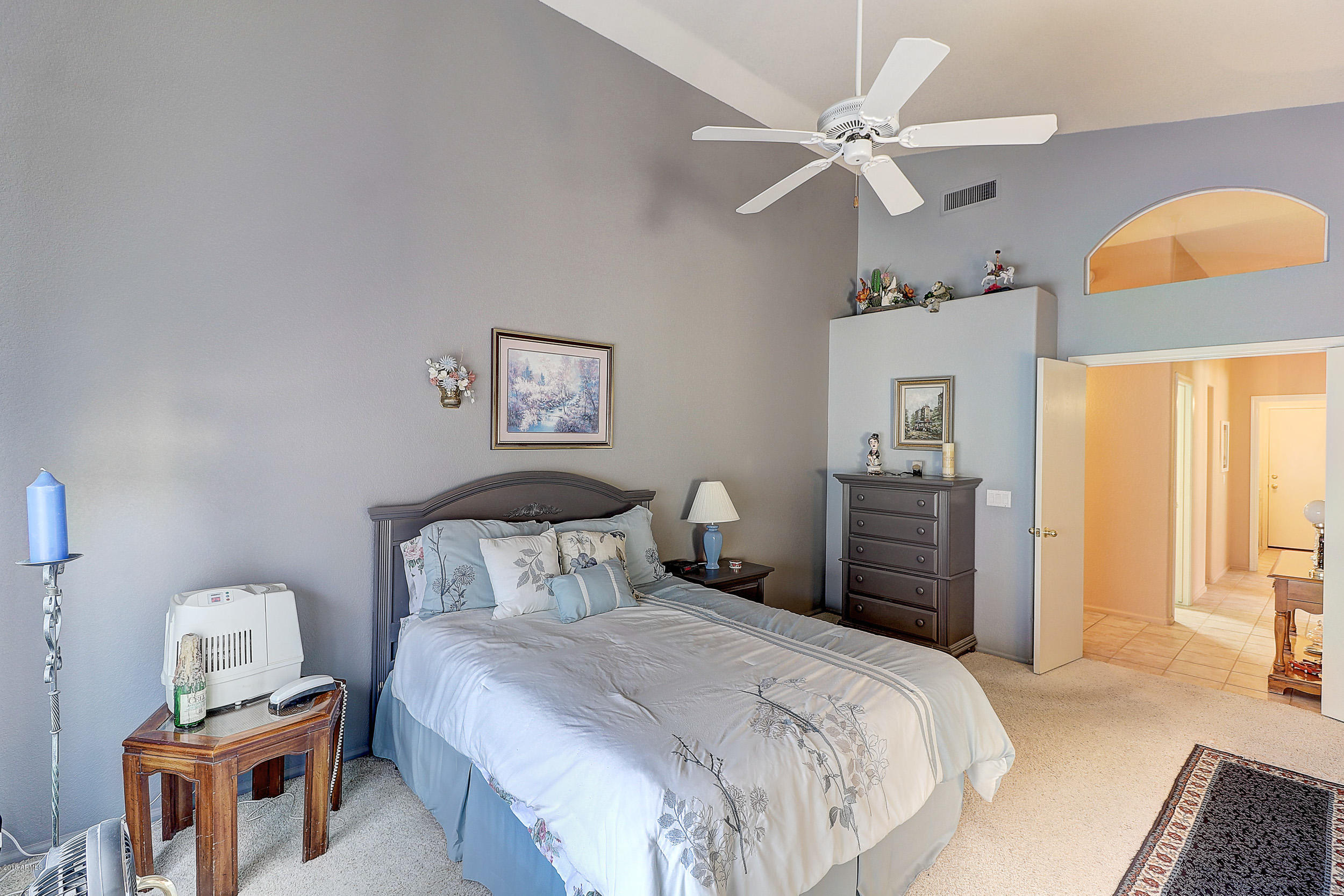 2101 East Escuda Road Phoenix, AZ 85024 - Photo 22 of 31 a bedroom with a bed and a chandelier