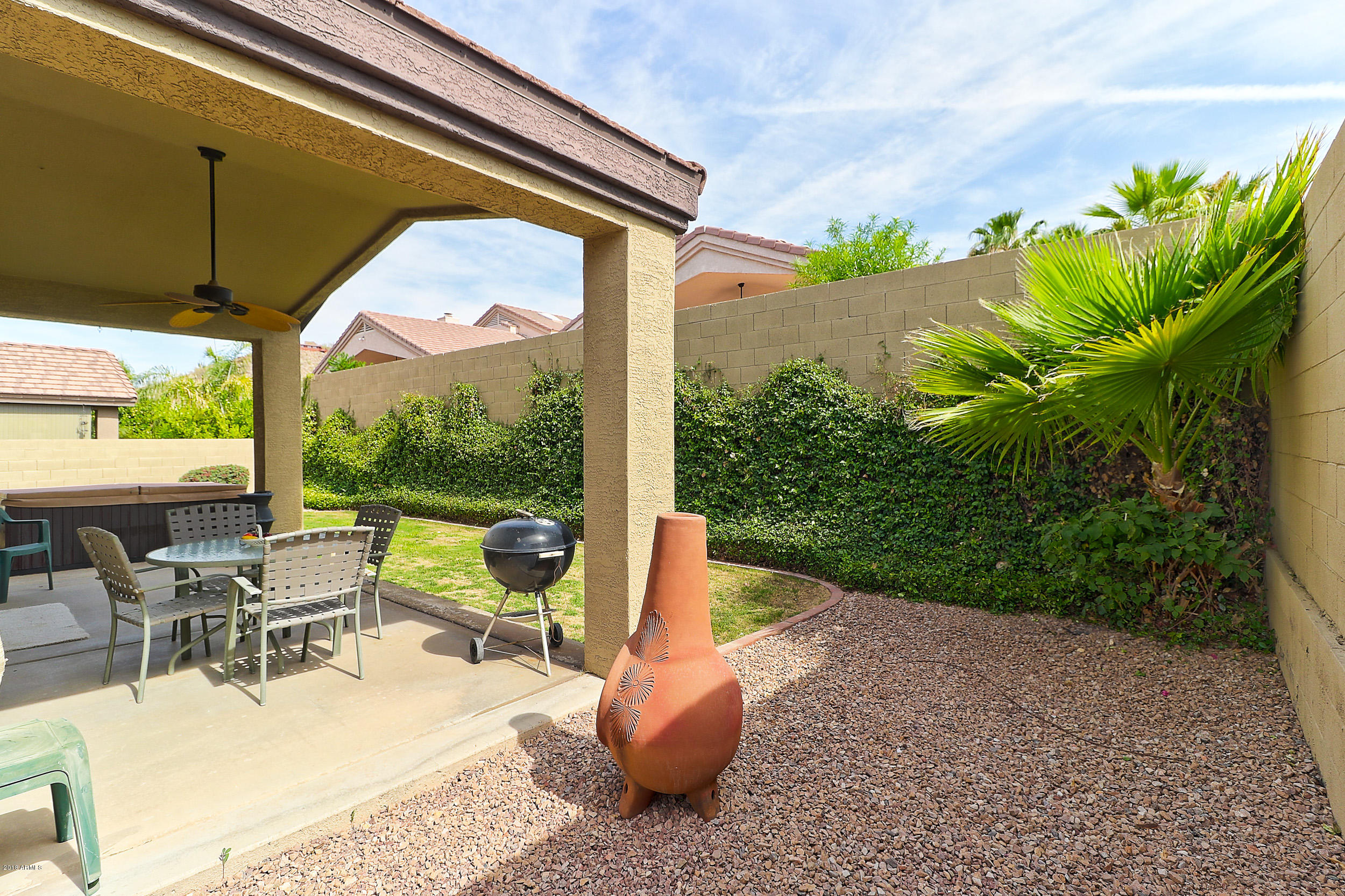 2101 East Escuda Road Phoenix, AZ 85024 - Photo 28 of 31 a view of a patio with table and chairs potted plants and floor to ceiling window