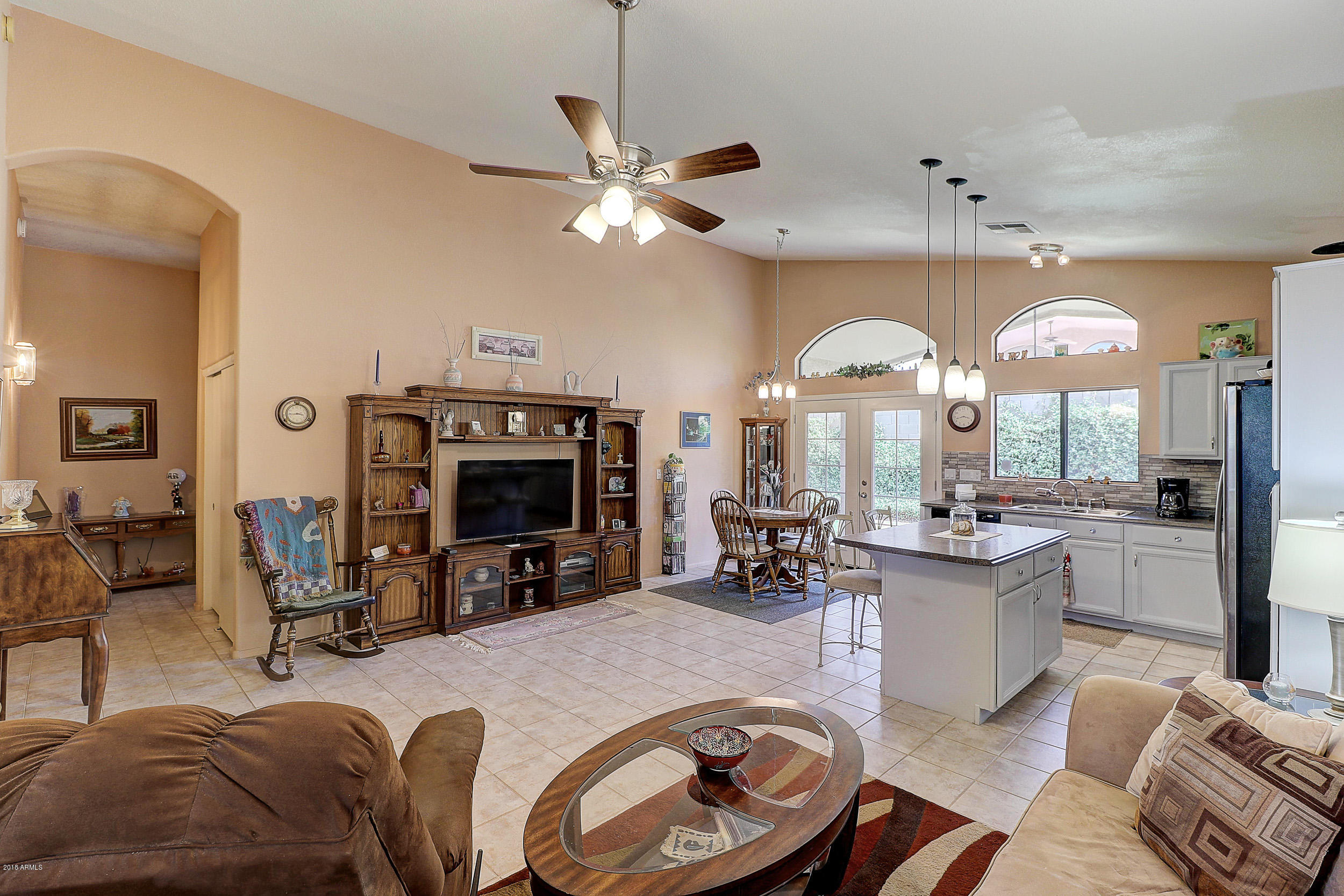 2101 East Escuda Road Phoenix, AZ 85024 - Photo 4 of 31 a living room with furniture a fireplace and a chandelier