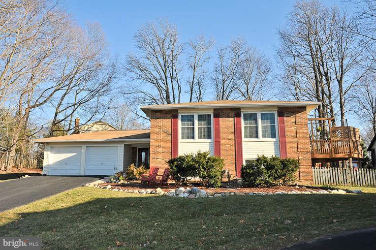 8901 Spur Road Springfield, VA 22153 - Photo 1 of 30 a front view of a house with a garden and porch