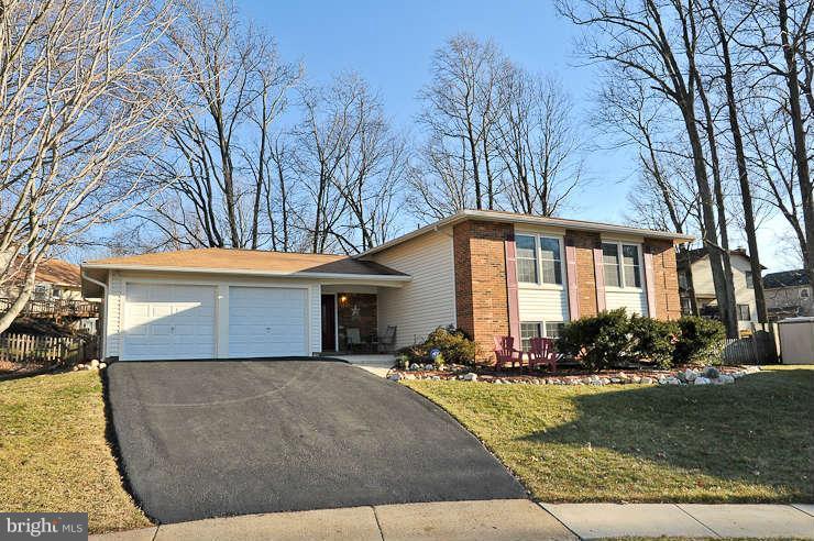 8901 Spur Road Springfield, VA 22153 - Photo 2 of 30 a front view of a house with swimming pool and outdoor seating