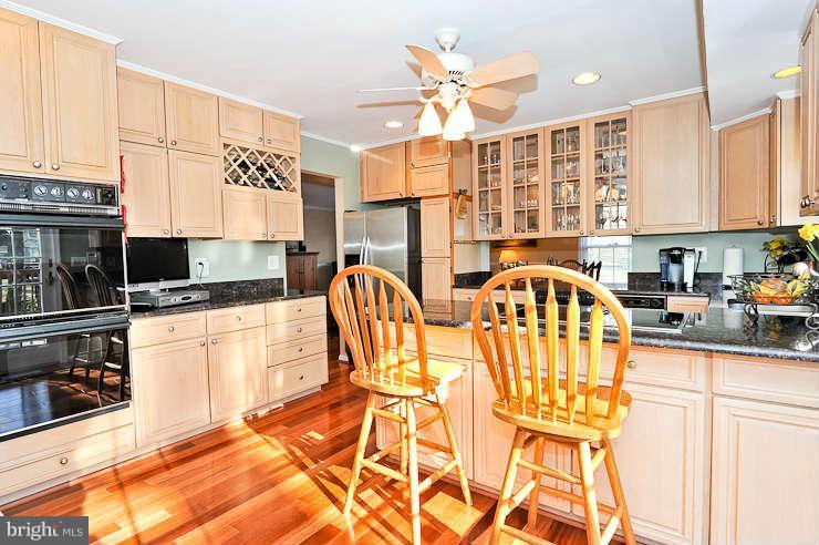 8901 Spur Road Springfield, VA 22153 - Photo 12 of 30 a kitchen with stainless steel appliances granite countertop a stove a sink and a microwave