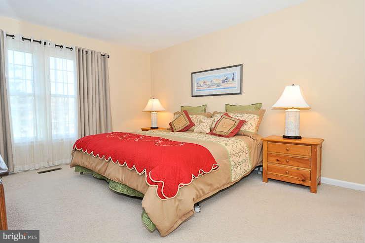 8901 Spur Road Springfield, VA 22153 - Photo 13 of 30 a spacious bedroom with a bed and a lamp