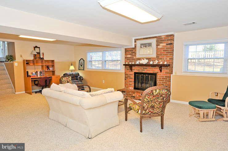 8901 Spur Road Springfield, VA 22153 - Photo 19 of 30 a living room with furniture and a fireplace