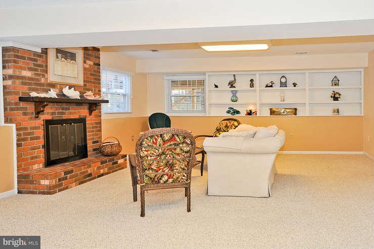 8901 Spur Road Springfield, VA 22153 - Photo 20 of 30 a living room with furniture a fireplace and a flat screen tv