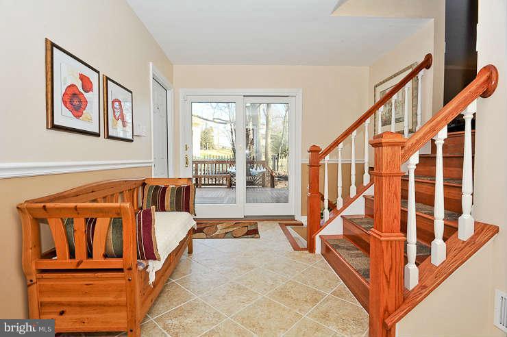 8901 Spur Road Springfield, VA 22153 - Photo 3 of 30 a view of a hallway with wooden floor and stairs