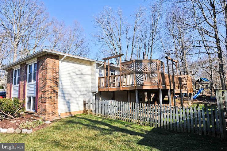 8901 Spur Road Springfield, VA 22153 - Photo 26 of 30 a front view of a house with a yard