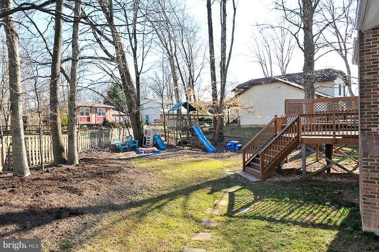 8901 Spur Road Springfield, VA 22153 - Photo 28 of 30 a view of a house with large trees and wooden fence