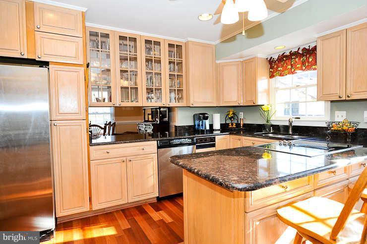 8901 Spur Road Springfield, VA 22153 - Photo 10 of 30 a kitchen with stainless steel appliances granite countertop a sink stove and refrigerator