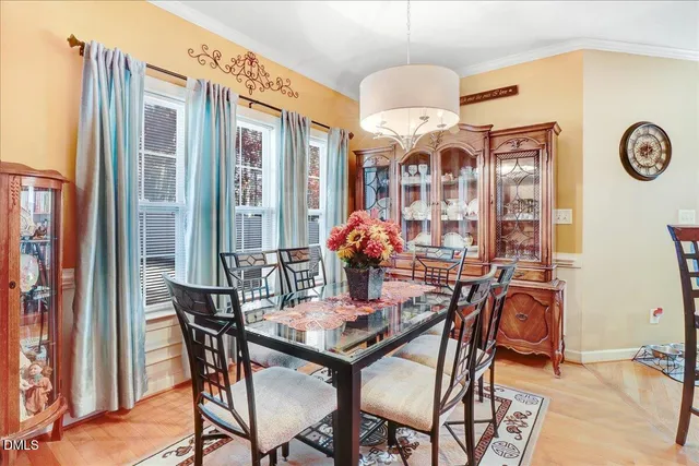 a dining room with furniture and chandelier
