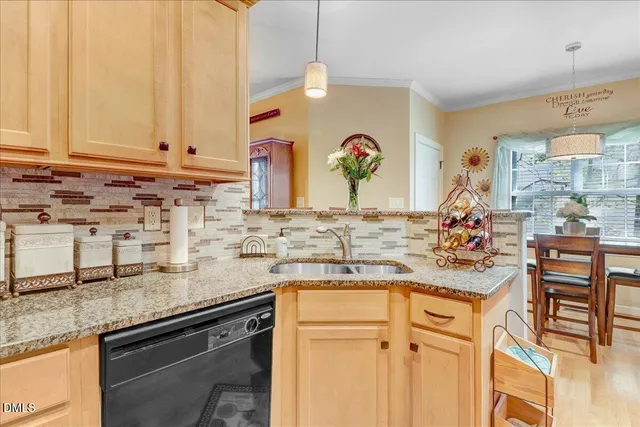 a kitchen with stainless steel appliances granite countertop a sink stove and cabinets