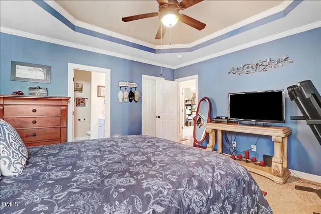 a bedroom with furniture and a flat tv screen