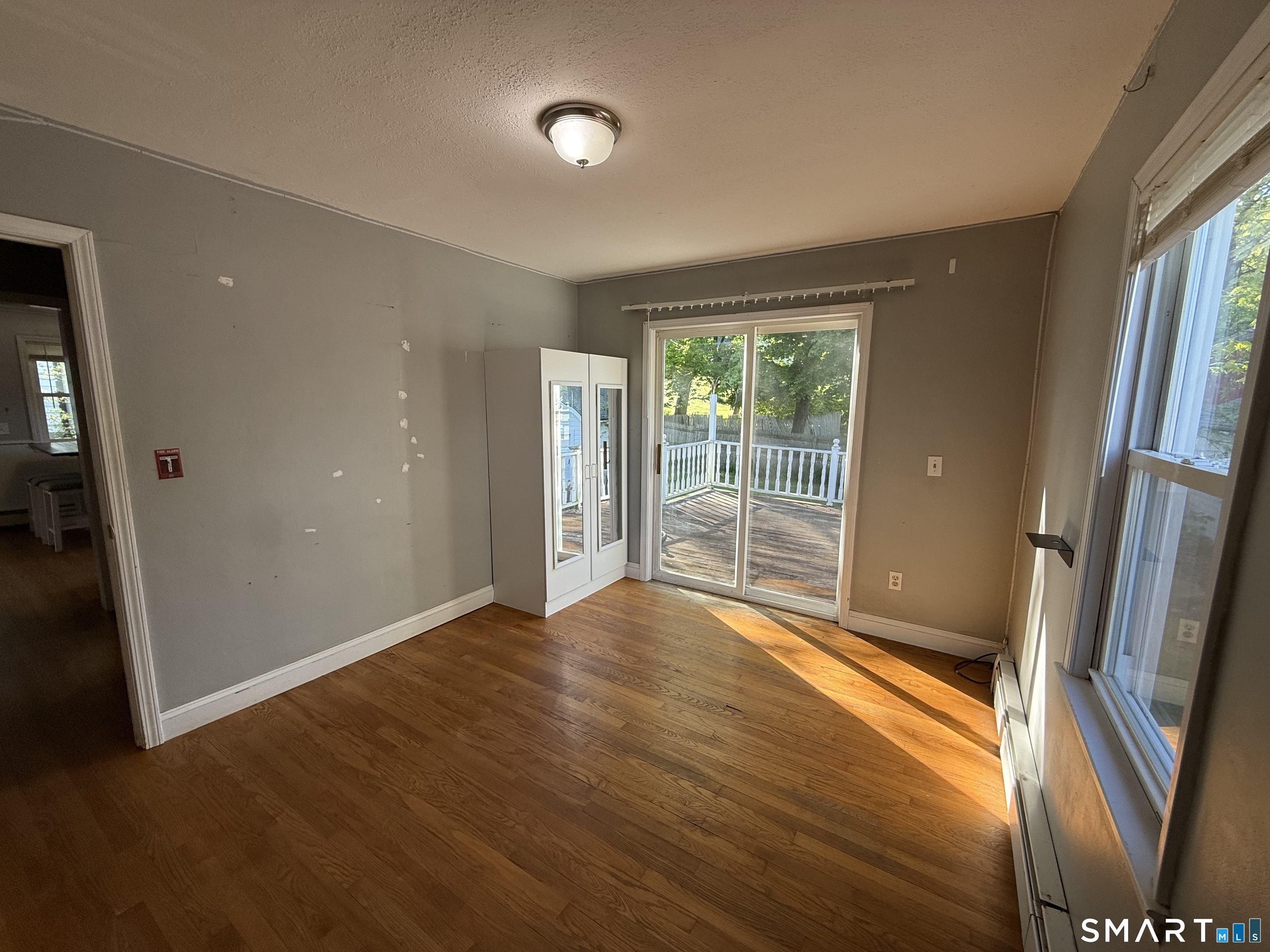 808 East Main Street Torrington, CT 06790 - Photo 27 of 40 an empty room with wooden floor and a window