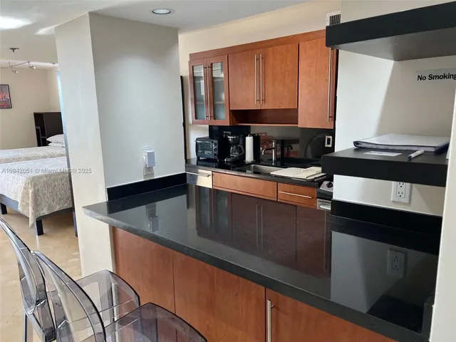 a kitchen with stainless steel appliances granite countertop a sink stove and microwave