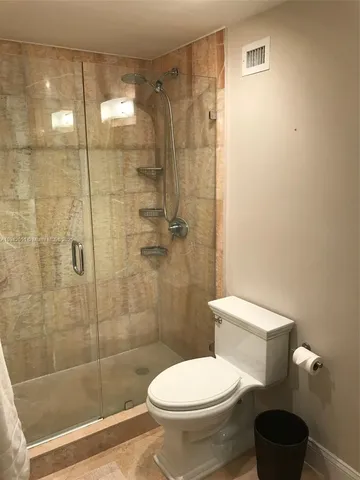 a bathroom with a toilet a sink and shower