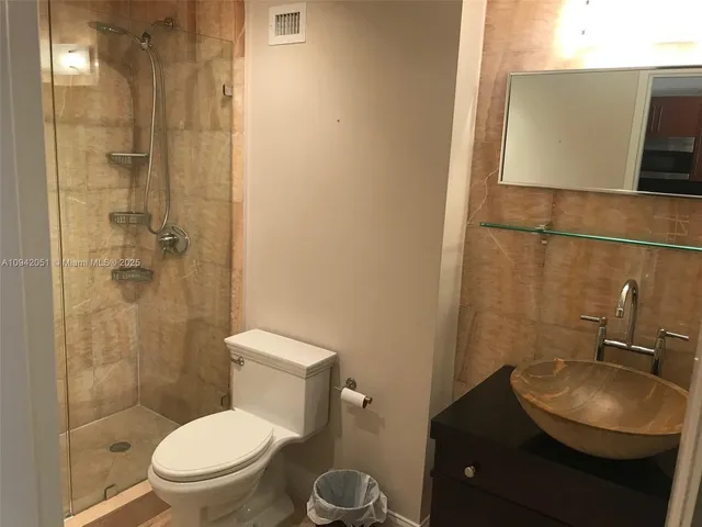 a white toilet sitting next to a bathroom sink