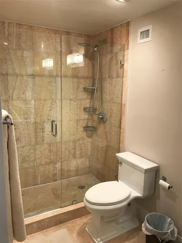 a bathroom with a toilet and a shower
