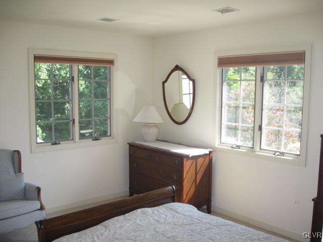 775 Texas Road Easton, PA 18042 - Photo 36 of 41 a bedroom with a bed mirror and a window