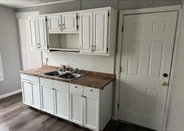 a kitchen with stainless steel appliances a sink a stove a refrigerator and cabinets