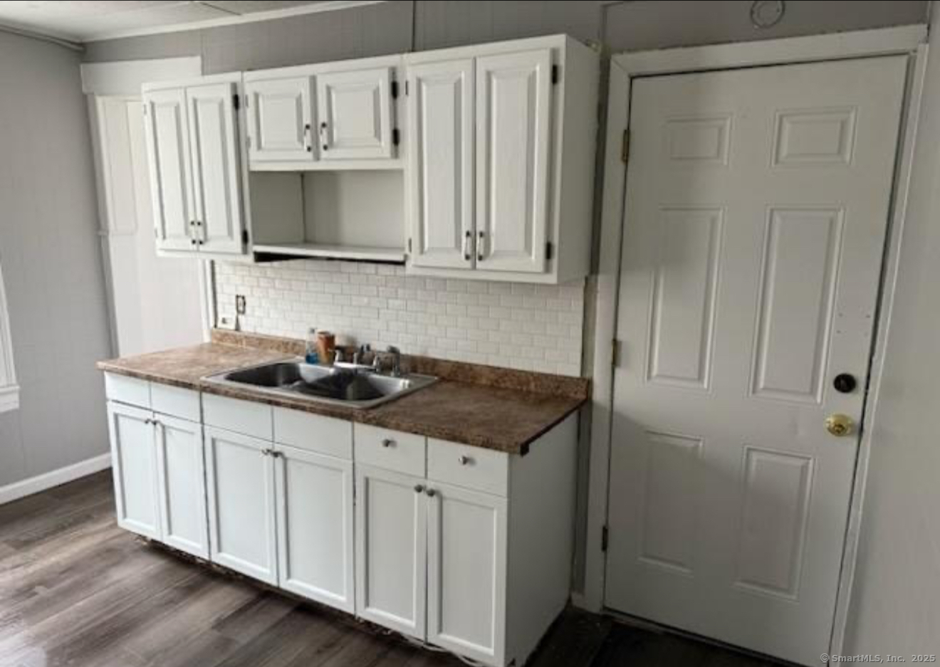 a kitchen with stainless steel appliances a sink a stove a refrigerator and cabinets