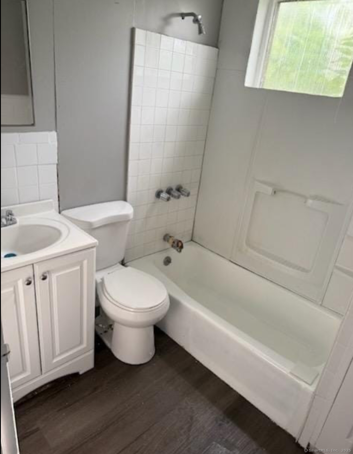 95 Center Street, Unit 2 Bridgeport, CT 06604 - Photo 2 of 4 a bathroom with a toilet a sink and bathtub