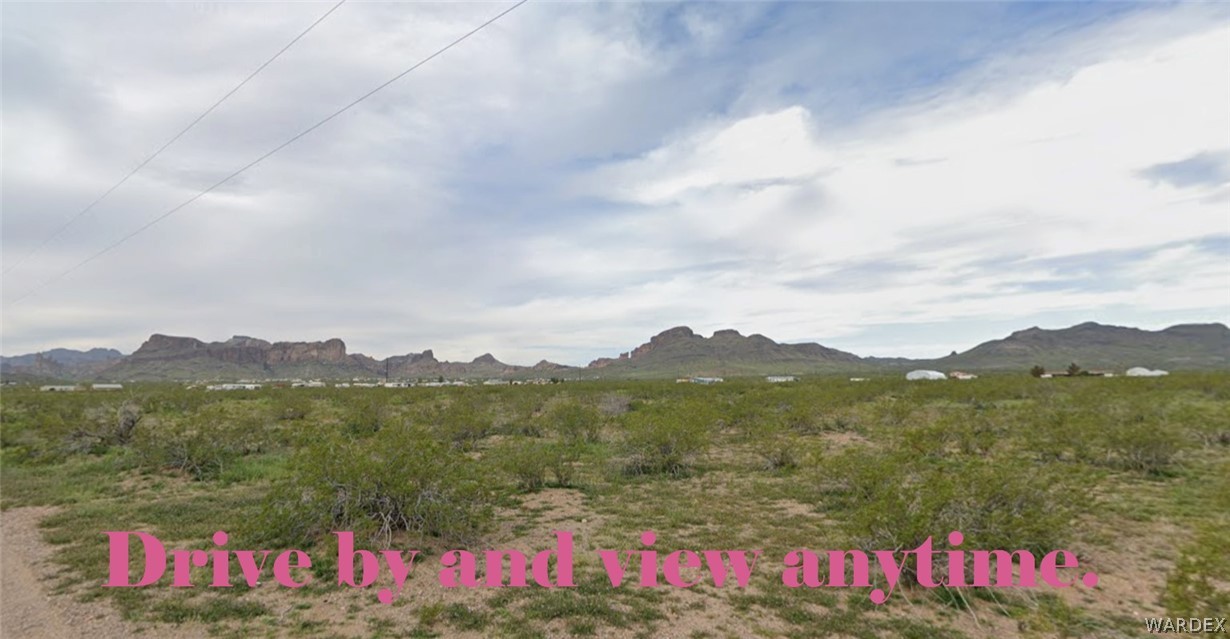 1065 South Dome Road Golden Valley, AZ 86413 - Photo 2 of 4 Expansive desert landscape featuring natural scrub vegetation and distant mountain ranges