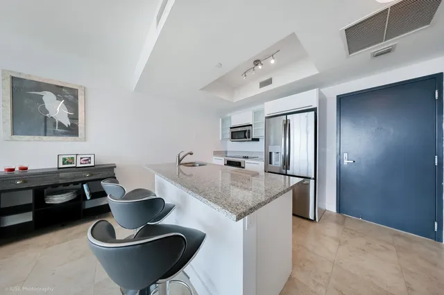 a kitchen with a table and chairs
