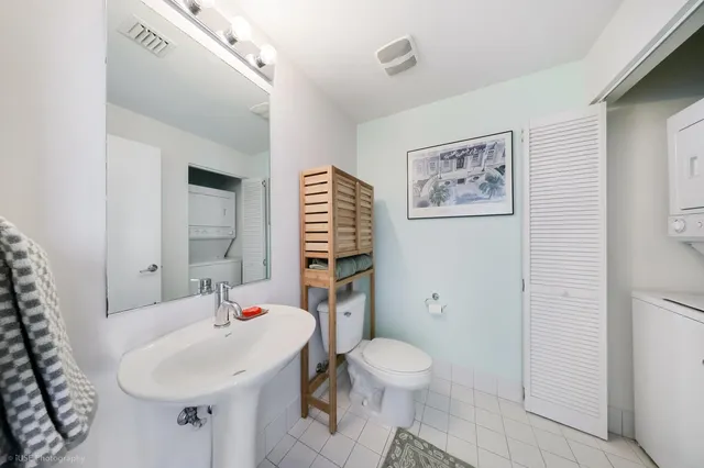 a bathroom with a sink toilet and a mirror