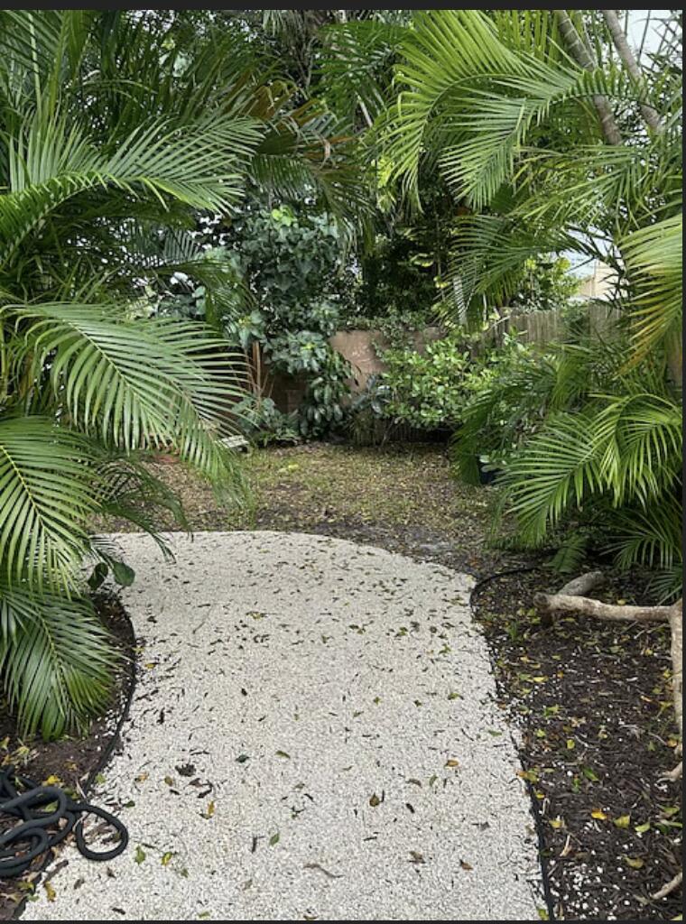 1822 Windsor Drive, Unit 1 Juno Ridge, FL 33408 - Photo 7 of 12 a view of a wooden fence