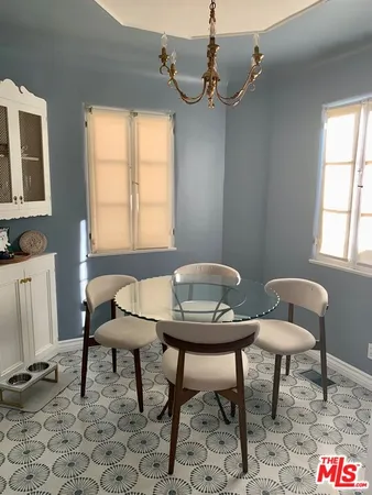a view of a dining room with furniture and a chandelier