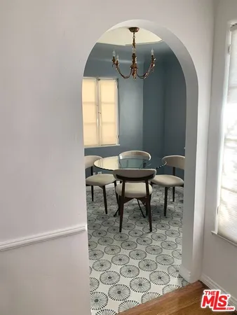 a kitchen with granite countertop a stove a sink and a refrigerator