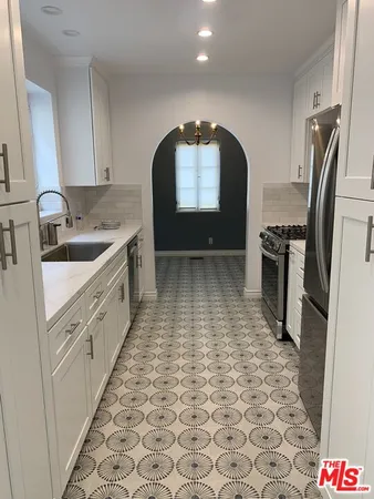 a kitchen with a sink stove and refrigerator