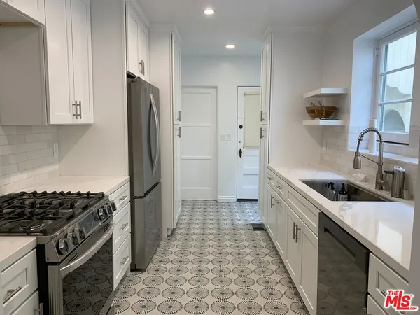 a kitchen with a sink cabinets and window