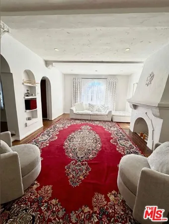 a living room with furniture fireplace and rug