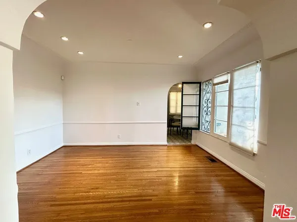 a view of a room with wooden floor