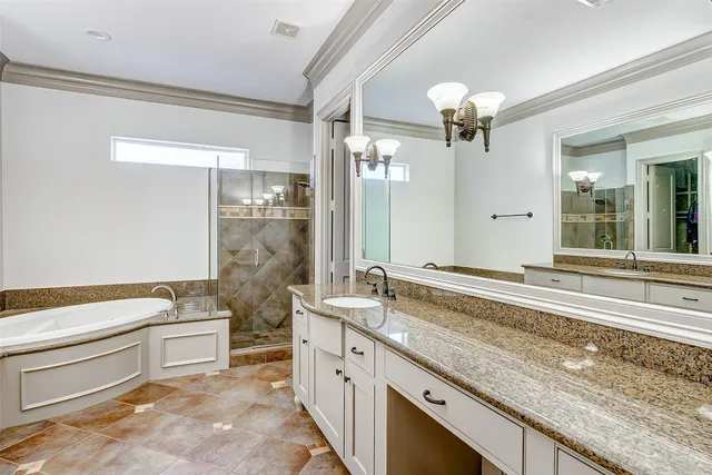 a spacious bathroom with a granite countertop sink a large mirror and a