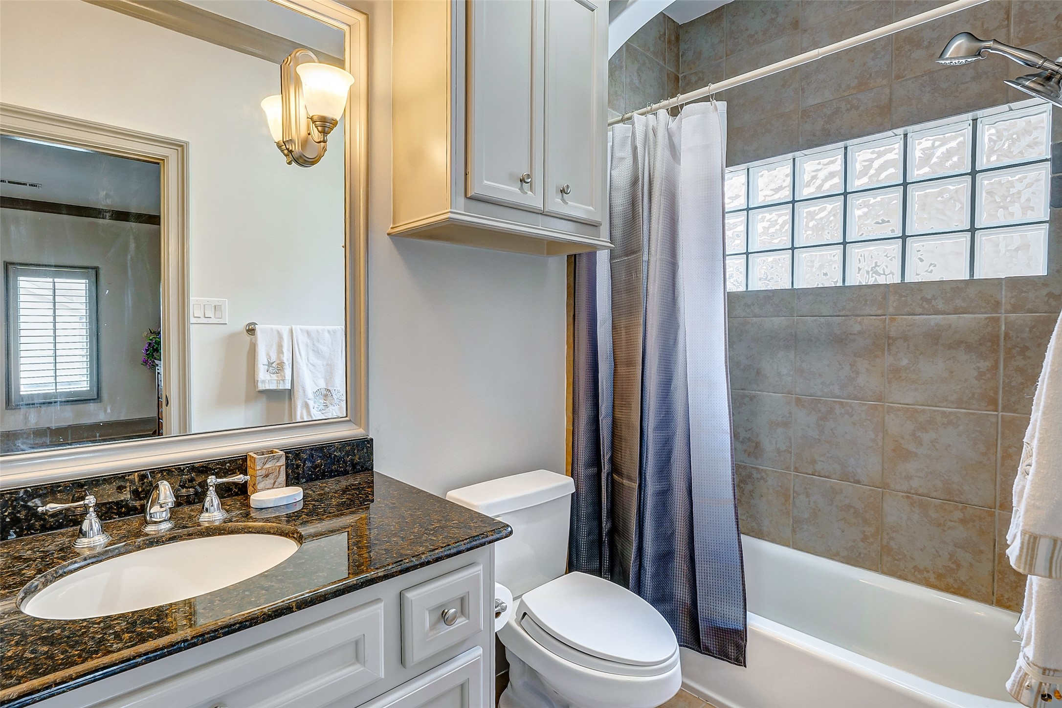 2702 Tudor Manor Houston, TX 77082 - Photo 21 of 25 a bathroom with a granite countertop sink toilet mirror and bathtub