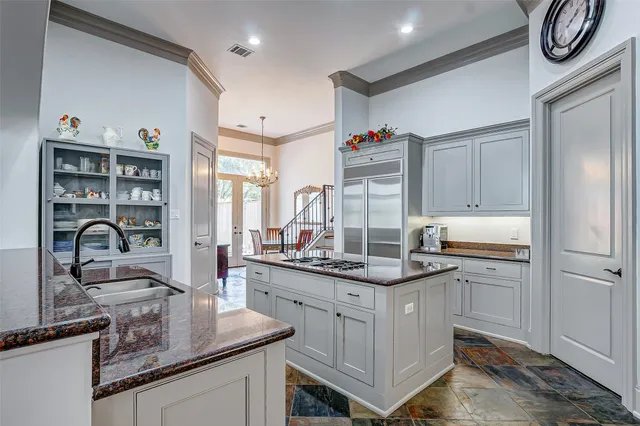 a kitchen with a sink appliances and cabinets