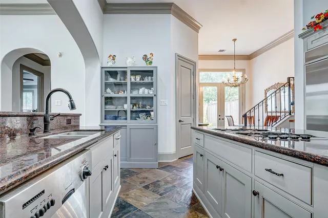 a kitchen with granite countertop a sink and cabinets